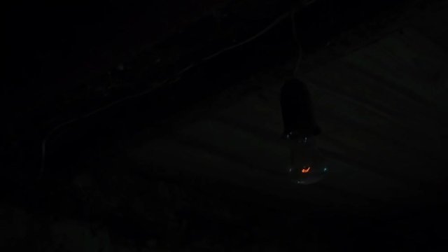 Flashing lightbulb In the old basement of the house