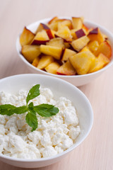 Photo of curd dessert with peaches and mint leaf