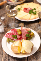 raclette cheese melted with potato and meats