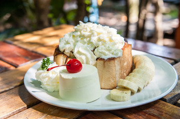 Toast with butter,whipped cream,ice cream,banana