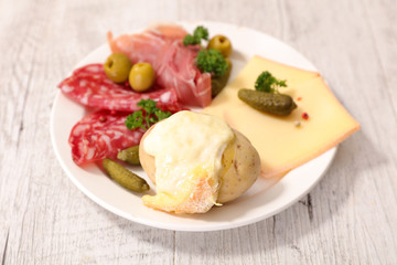 raclette cheese melted with potato and meats