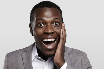 Human face expressions and emotions. Body language. Portrait of dark-skinned businessman looking at...