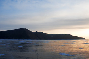 Winter. Ice on the surface of Lake Baikal. Ice thickness of about one meter. Cracks in the ice surface. Ice storm. Used toning of the photo.