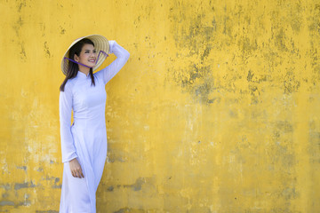 Beautiful woman with Vietnam culture traditional dress, Ao dai is famous traditional costume , vintage style, Hoi an Vietnam