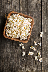 Popcorn on wooden table.