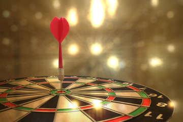 target dart with arrow over blurred bokeh background ,metaphor to target marketing or target arrow...