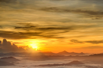 Fototapeta na wymiar Beautiful golden sky over the layers of hill with sea of fogs