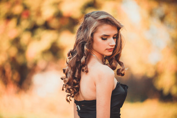 Fototapeta premium Lady in a luxury lush pink pastel dress near the tree,fantastic shot,fairytale princess is walking in the autumn forest,fashionable toning,creative computer colors
