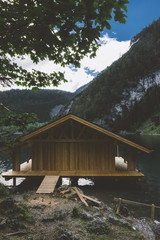 Wood house on lake with mountains and trees - 121650804