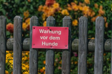 Holzzaun mit Warnschild Hund