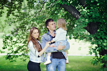 Family - mom, dad and daughter in the Park.