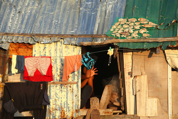 Fototapeta na wymiar poor colorful house in asian island with laundry and dried fish on a roof