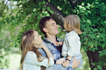 Fototapeta premium Family - mom, dad and little daughter on nature.