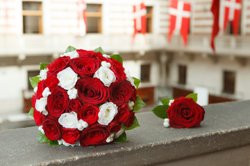Red and white wedding bouquet and a boutonniere