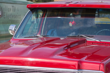 Red retro car. The view from the side. Chrome lining. An American classic.