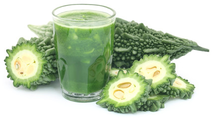 Green momodica with juice in a glass