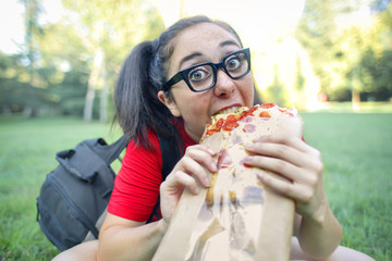 Greedy girl eating pizza