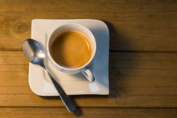 Espresso Cup on wooden table viewed from above