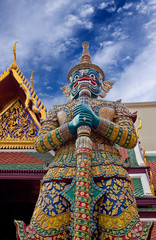Fototapeta na wymiar Giant demon Yaksha guarding an exit to Wat Phra Kaew in Bangkok, Thailand.