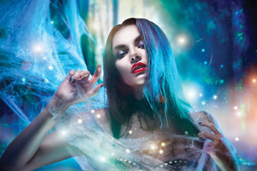Beautiful Halloween witch portrait. Sexy model girl with Halloween makeup
