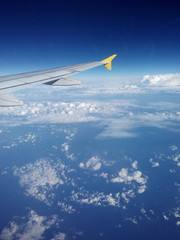 airplane wing, flying above the clouds
