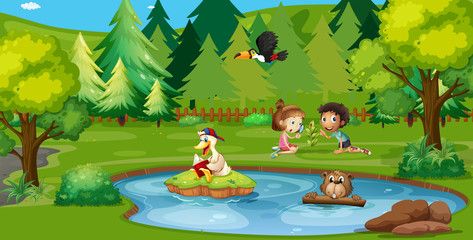 Obraz na płótnie Canvas Boy and girl playing by the pond