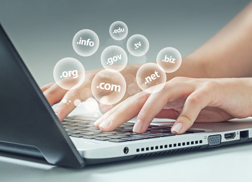 female hand typing on laptop, internet extensions flying