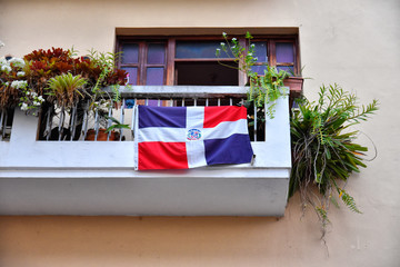 Santo Domingo, Dominican Republic. Balcony with dominican flag. - obrazy, fototapety, plakaty