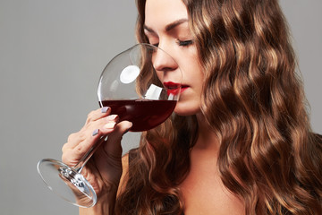 gorgeous sexy girl with glass of red wine.Beautiful woman drinking wine.make-up
