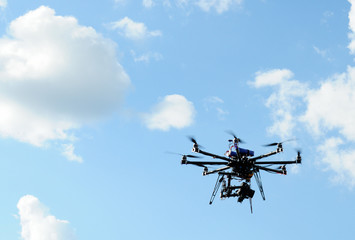 octocopter drone with digital camera in flight, used toning of the photo