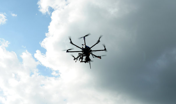 octocopter drone with digital camera in flight, used toning of the photo