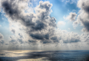 Fototapeta premium Beautiful autumn clouds in the sky over the sea. HDR photo