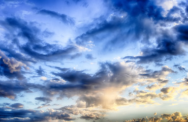 Beautiful blue sky with cumulus clouds at sunset. HDR photo