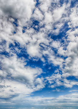 Bright blue sky with cumulus white clouds. HDR photo