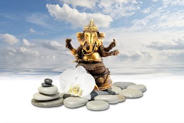 Ganesha or Ganapati,zen stone,white orchid flowers and sky reflected in water