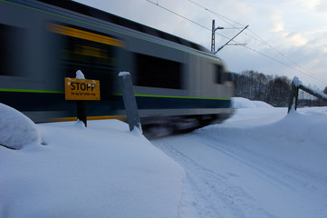 Train passing train crossing at winter