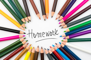 Colouring pencils in circle arrangement with message Homework