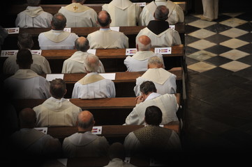 Priests sitting in church.