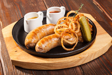 Fried sausages with sauces and potatoes