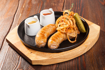 Fried sausages with sauces and potatoes