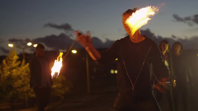 Male Artist Performing Fire Show Outdoors at Evening Time. Shot on RED Cinema Camera in 4K (UHD).