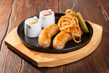 Fried sausages with sauces and potatoes