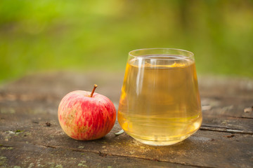 Delicious fresh squeezed apple juice in  transparent glass