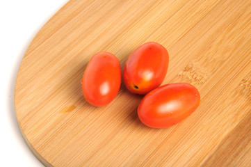 red cherry tomatoes on Bamboo cutting board