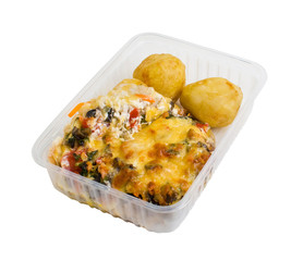 Baked meat with potatoes in a plastic food container. Isolated on white background