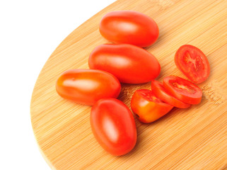 red cherry tomatoes on Bamboo cutting board