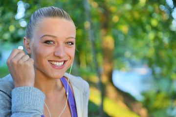 Young woman taking rest after jogging - workout at the park