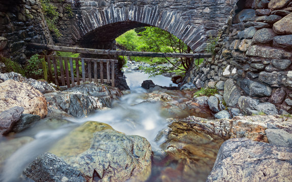 Scenic Stone Bridge over Mountain Creek in Lake District National Park