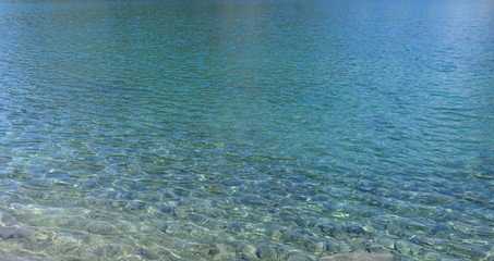 Blue clear water shines at Iceberg Lake in summer