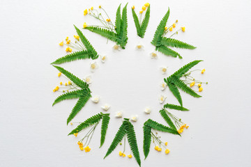 Wreath with jasmine ranunculus and leaves of green fern